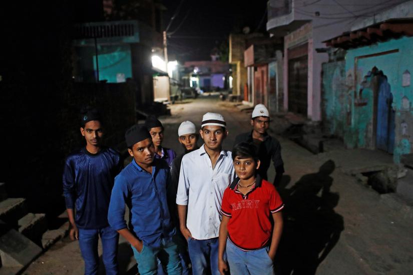 Mulsim children stand outside a mosque as they arrive to offer their morning prayer during the holy month of Ramadan in village Nayabans in the northern state of Uttar Pradesh, India May 10, 2019. Picture taken on May 10, 2019. REUTERS