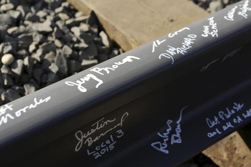 California Governor Jerry Brown`s name and others are pictured on a railroad rail after a ceremony for the California High Speed Rail in Fresno, California Jan 6, 2015. REUTERS