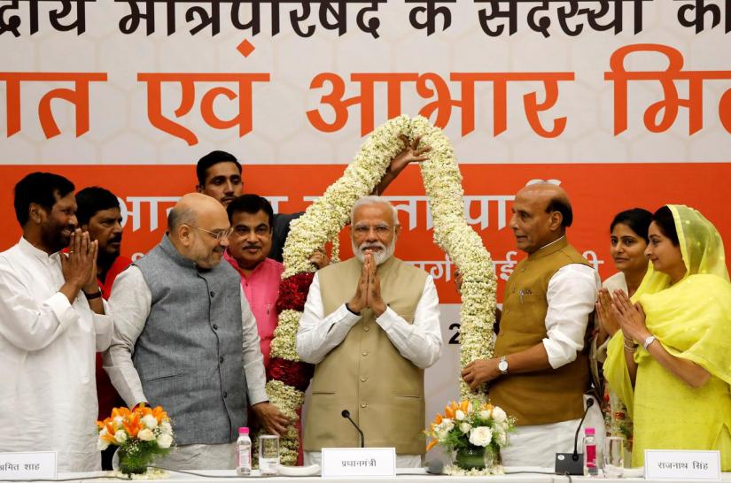 India`s Prime Minister Narendra Modi gestures as he is presented with a garland during a thanksgiving ceremony by Bharatiya Janata Party (BJP) leaders to its allies at the party headquarters in New Delhi, India, May 21, 2019. REUTERS/File Photo