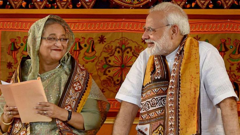 This May 2018 photo shows Prime Minister Sheikh Hasina speaking with her Indian counterpart Narendra Modi during the annual convocation of Visva Bharati University at Birbhum in the Indian state of West Bengal. PTI