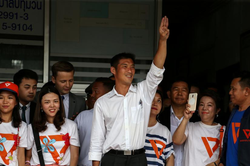 FILE PHOTO: Thanathorn Juangroongruangkit, leader of the Future Forward Party flashes a three-finger salute to his supporters as he leaves a police station after hearing a sedition complaint filed by the army, in Bangkok, Thailand, April 6, 2019. REUTERS