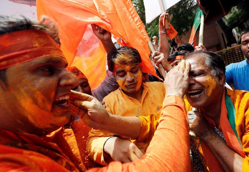BJP supporters celebrate after learning the initial election results outside the party headquarters in New Delhi, India, May 23, 2019. REUTERS