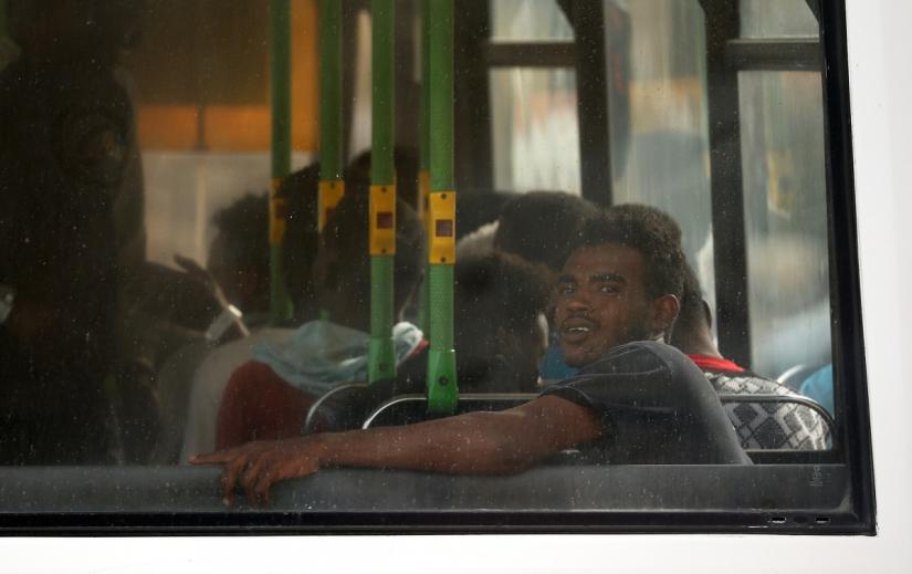 Migrants sit on a police bus after disembarking from an Armed Forces of Malta patrol boat at its base in Marsamxett Harbour, Valletta, Malta May 25, 2019. REUTERS