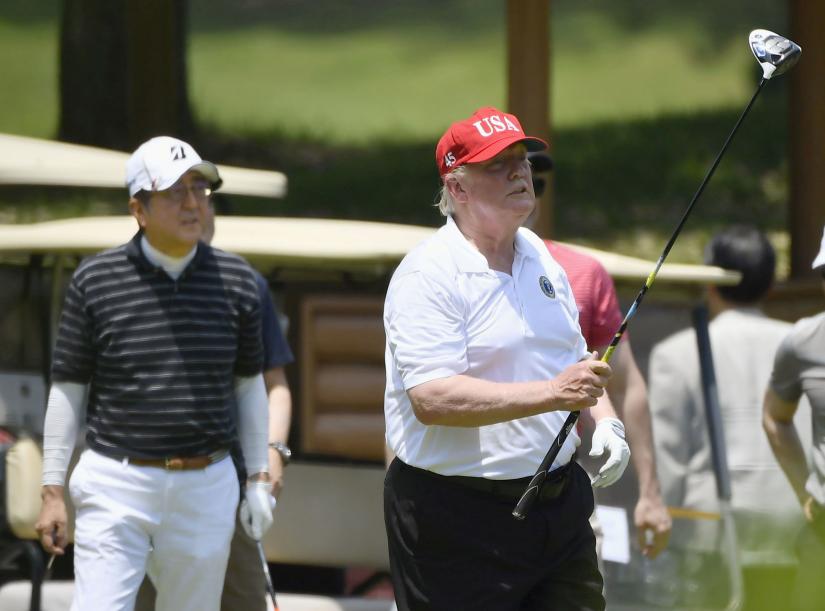 US President Donald Trump and Japan`s Prime Minister Shinzo Abe play golf at Mobara Country Club in Mobara, Chiba prefecture, Japan May 26, 2019, in this photo taken by Kyodo via REUTERS