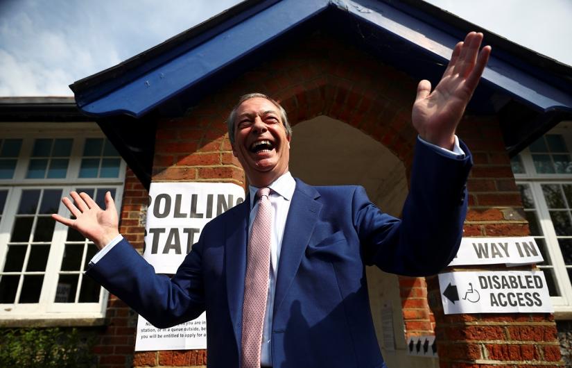 Brexit Party leader Nigel Farage gestures as he leaves a polling station after voting in the European elections, in Biggin Hill, Britain, May 23, 2019. REUTERS