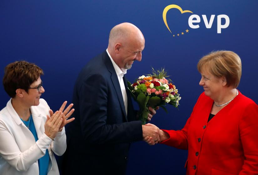German Chancellor Angela Merkel and Annegret Kramp-Karrenbauer, Chairwoman of Germany`s Christian Democratic Union party (CDU) congratulate Carsten Meyer-Heder, CDU top candidate for the German city-state of Bremen parliamentary elections, at a party board meeting in Berlin, Germany, May 27, 2019. REUTERS