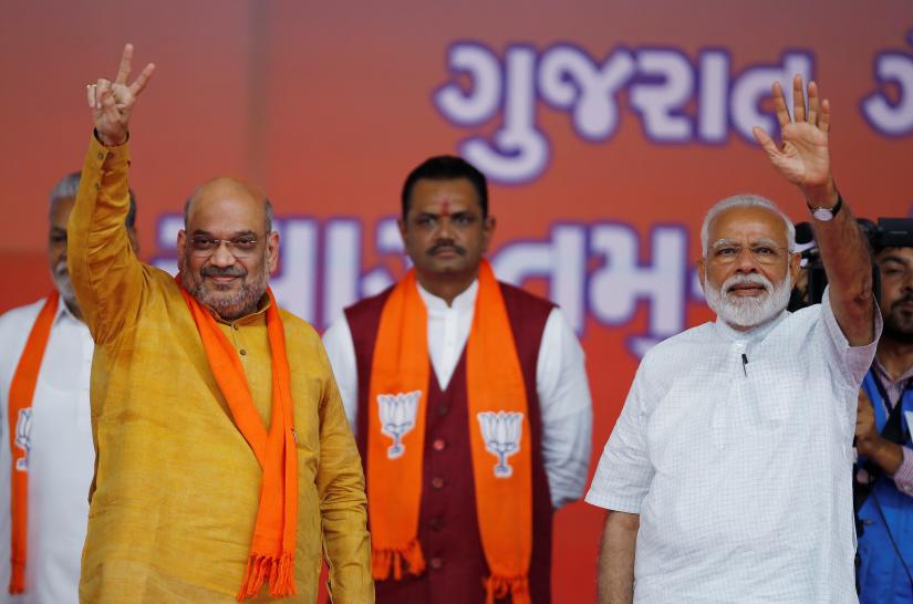 India`s Prime Minister Narendra Modi and Bharatiya Janata Party (BJP) President Amit Shah wave toward their supporters at a public meeting in Ahmedabad, India, May 26, 2019. REUTERS