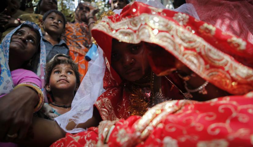 Child bride Krishna,11, sits during a marriage ceremony at her husband`s home in a village near Kota, located in the northwestern state of Rajasthan, on May 16, 2010. REUTERS/File Photo