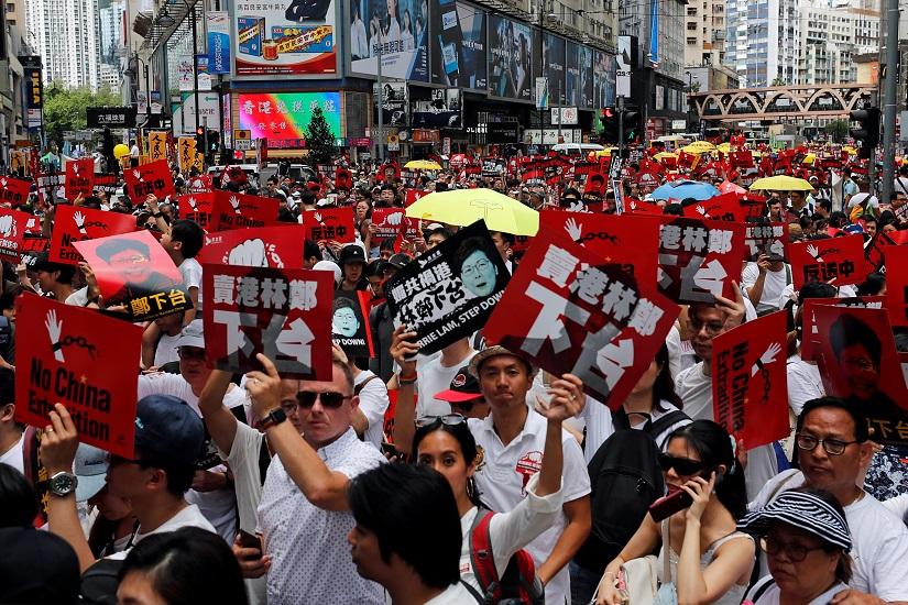 Demonstrators hold yellow umbrellas, the symbol of the Occupy Central movement, and placards during a protest to demand authorities scrap a proposed extradition bill with China, in Hong Kong, China June 9, 2019. REUTERS