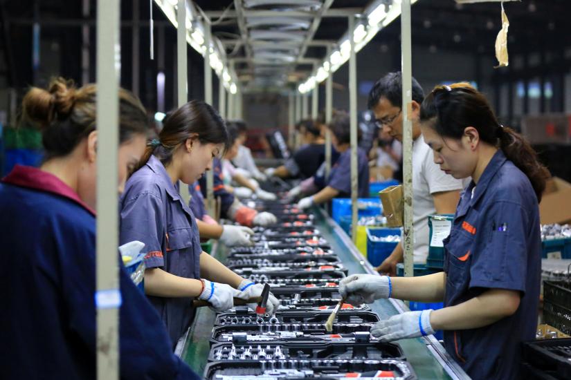 Employees work on a production line manufacturing tools at a factory in Huaian, Jiangsu province, China May 26, 2019. REUTERS