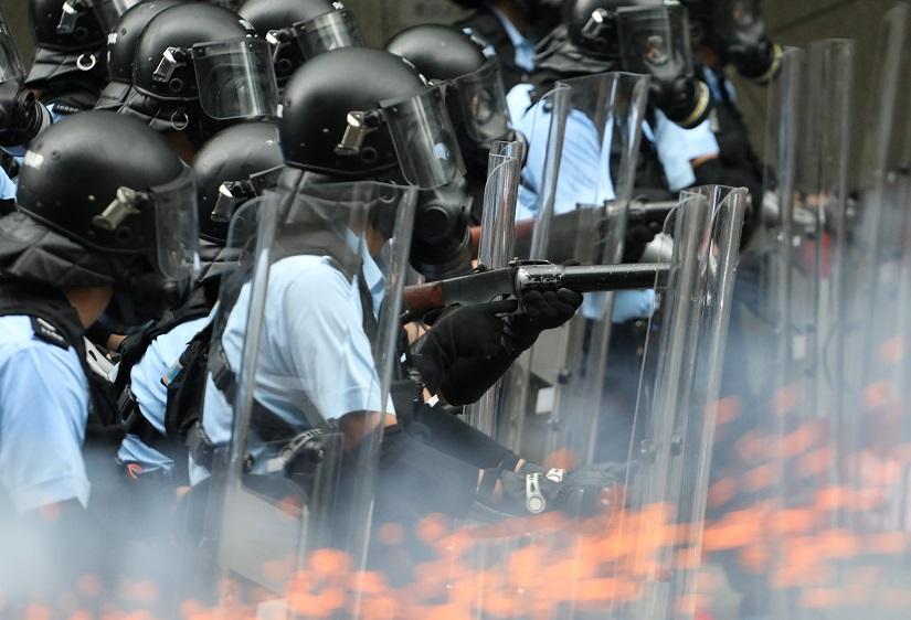 Police officers fire tear gas at protesters during a demonstration against a proposed extradition bill in Hong Kong, China June 12, 2019. REUTERS