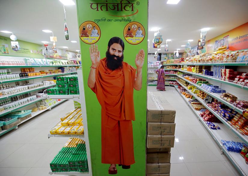 A hoarding with an image of Baba Ramdev is seen inside a Patanjali store in Ahmedabad, India, March 28, 2019. REUTERS