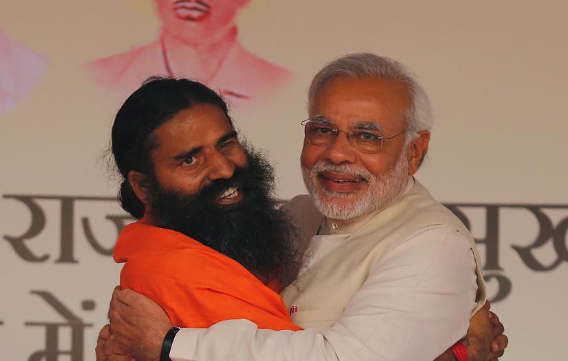 Narendra Modi and yoga tycoon Baba Ramdev embrace at a rally in New Delhi on March 23, 2014, two weeks before the start of national elections that would see Modi elected prime minister. REUTERS