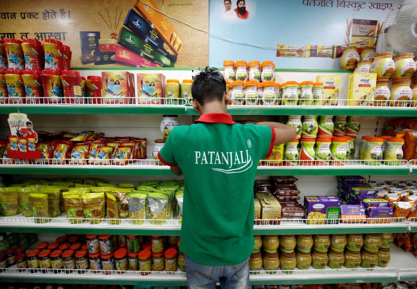 A worker arranges consumable goods inside a Patanjali store in Ahmedabad, India, March 28, 2019. Picture taken March 28, 2019. REUTERS