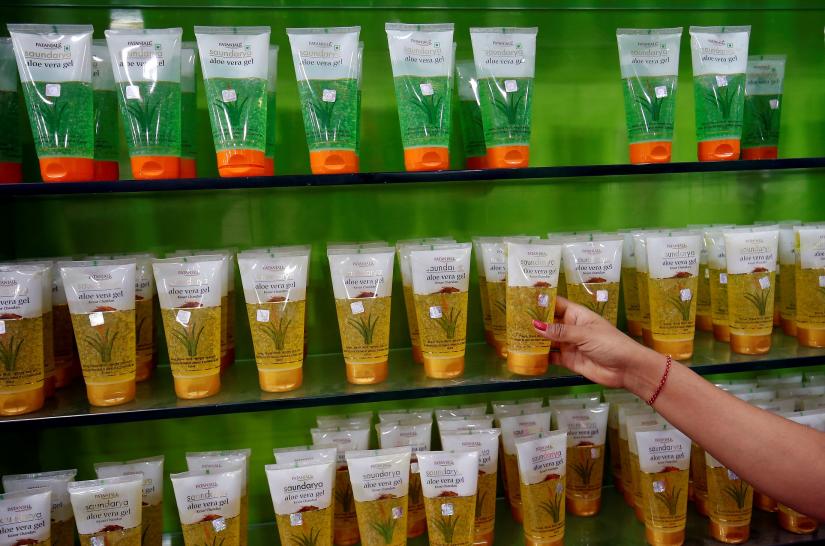 A woman checks a skin care product inside a Patanjali store in Ahmedabad, India, March 28, 2019. REUTERS