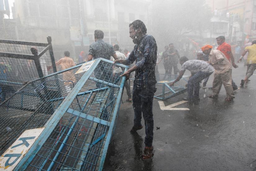 Supporters of India’s Bharatiya Janata Party (BJP) break barricades as police use water cannon to disperse them during a protest against what they call violence against their party workers in the state of West Bengal, in Kolkata, India, June 12, 2019. REUTERS
