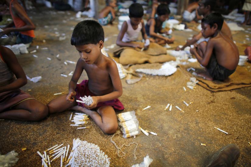 Children fill up empty cigarettes manually with locally grown tobacco in a small bidi (cigarette) factory at Haragach in Rangpur district, Bangladesh July 11, 2013. REUTERS/File Photo