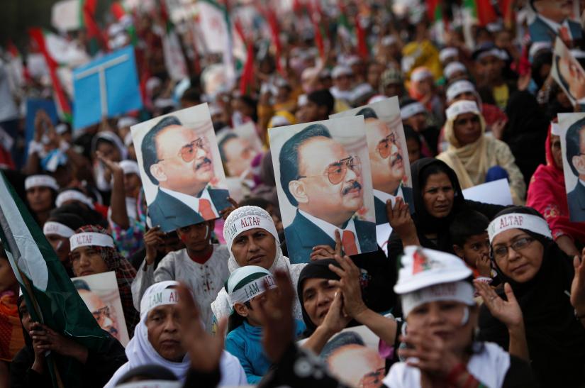 Supporters of Pakistan`s Muttahida Qaumi Movement (MQM) political party hold posters with a picture of their leader Altaf Hussain during a rally to demonstrate their solidarity to their leader in Karachi February 2, 2014. REUTERS