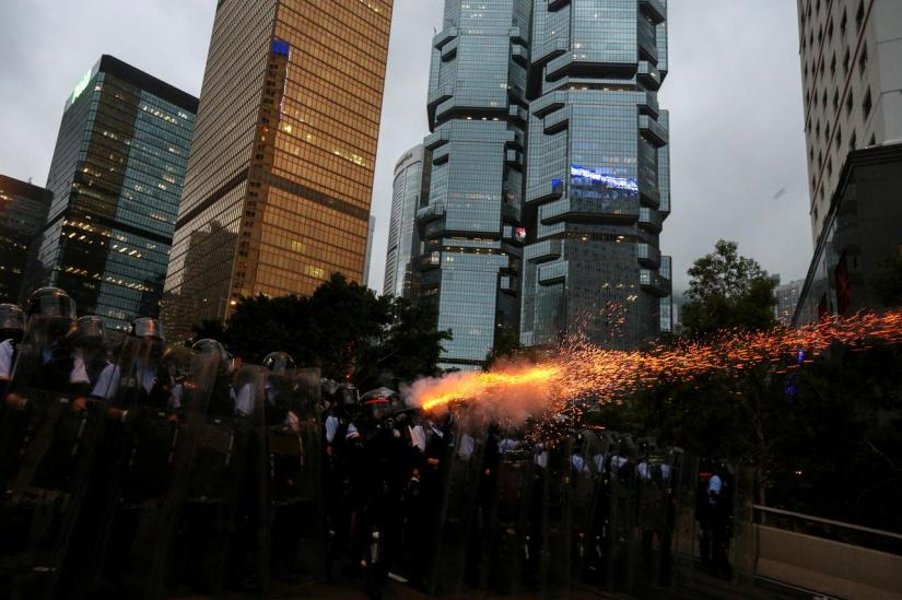 Police officers fire tear gas during a demonstration against a proposed extradition bill in Hong Kong, China June 12, 2019. REUTERS