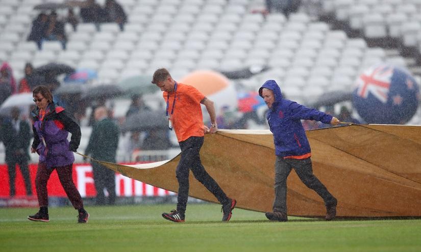Groundstaff put covers on the pitch as rain delays play  - ICC Cricket World Cup - India v New Zealand - Trent Bridge, Nottingham, Britain - June 13, 2019. Reuters