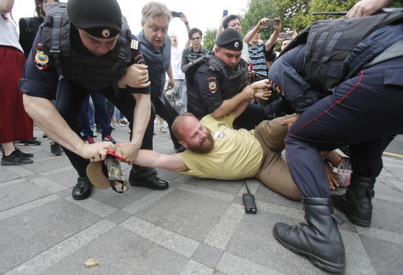 Law enforcement officers detain a participant of a rally in support of Russian investigative journalist Ivan Golunov, who was detained by police, accused of drug offences and later freed from house arrest, in Moscow, Russia June 12, 2019. REUTERS