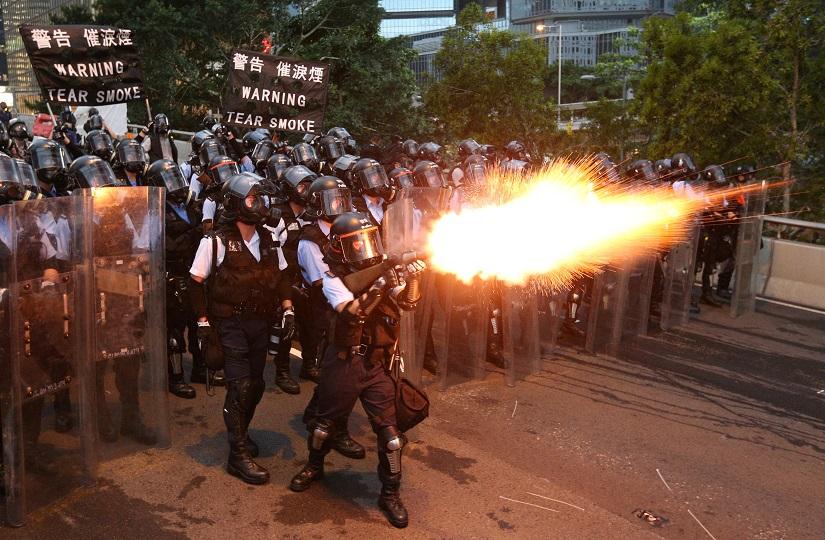 Police officers fire a tear gas during a demonstration against a proposed extradition bill in Hong Kong, China June 12, 2019. REUTERS