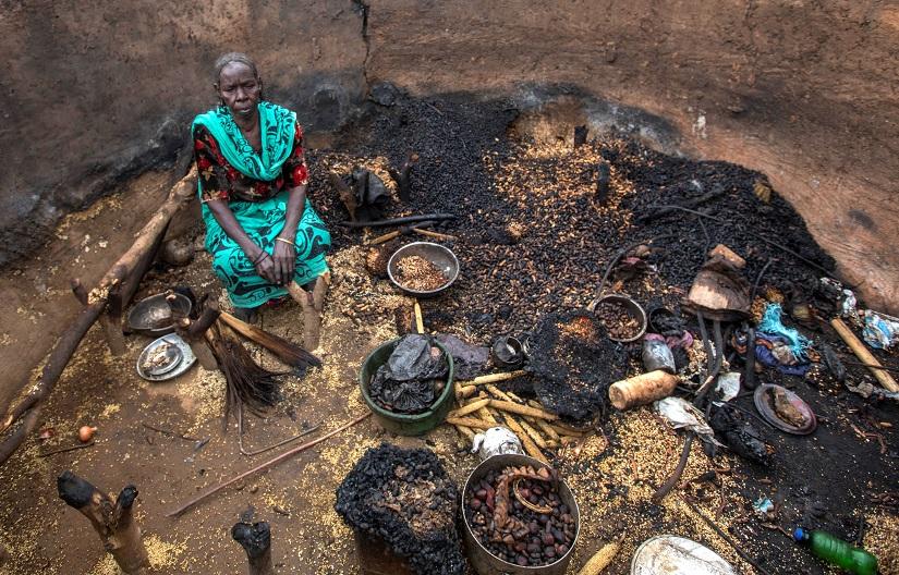 A woman sits in a burnt house during the clashes between nomads and residents in Deleij village, located in Wadi Salih locality, Central Darfur, Sudan June 11, 2019. Picture taken June 11, 2019. REUTERS