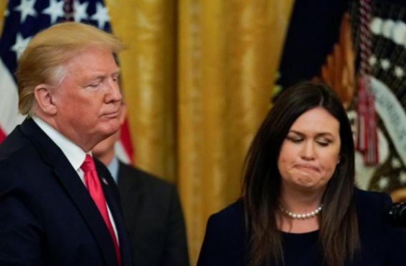 US President Donald Trump with White House Press Secretary Sarah Sanders after it was announced she will leave her job at the end of the month during a second chance hiring prisoner reentry event in the East Room of the White House in Washington, US, June 13, 2019. REUTERS