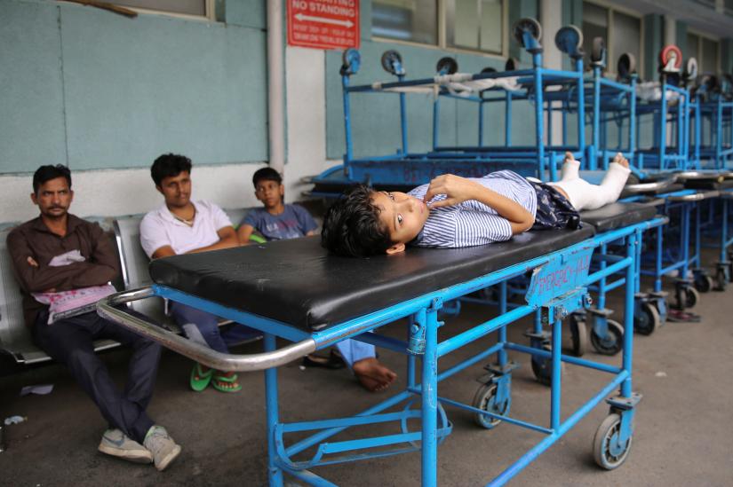 A boy lies on a stretcher waiting for treatment during a nationwide doctors strike demanding security after the recent assaults on them by the patients` relatives, in New Delhi, India, June 17, 2019. REUTERS