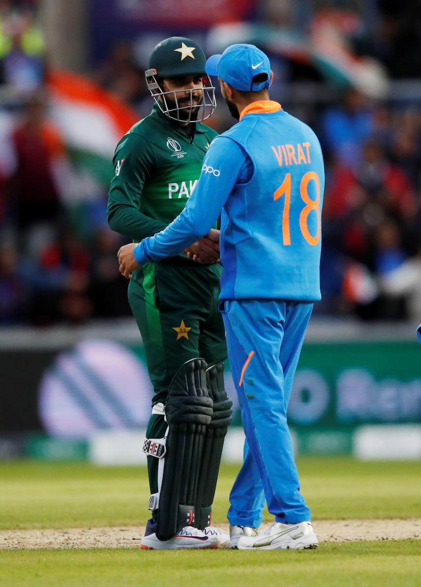 Cricket - ICC Cricket World Cup - India v Pakistan - Emirates Old Trafford, Manchester, Britain - June 16, 2019 India`s Virat Kohil shakes hands with Pakistan`s Shadab Khan after the match Action Images via Reuters