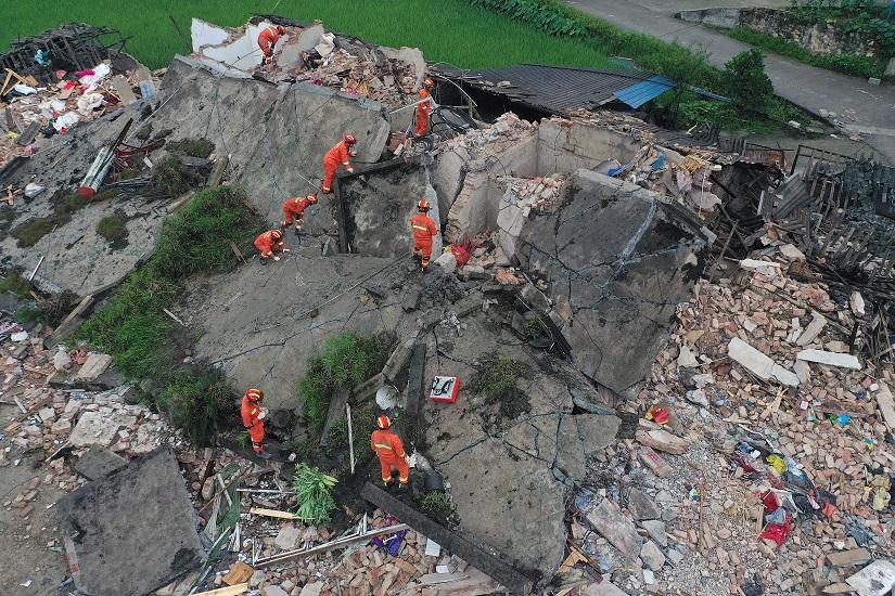 Rescue workers are seen on a collapsed house after earthquakes hit Changning county in Yibin, Sichuan province, China June 18, 2019. REUTERS