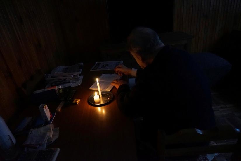 A man writes by candlelight as his neighbourhood Parque Batlle goes without electricity, although power has mostly been restored after a massive blackout in Argentina cut electricity to much of neighbouring Uruguay and swaths of Paraguay, in Montevideo, Uruguay June 16, 2019. REUTERS