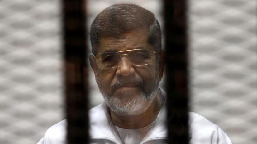 Ousted Egyptian President Mohamed Mursi is seen behind bars during his trial at a court in Cairo May 8, 2014. REUTERS/File Photo