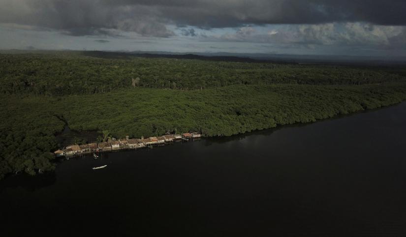 An unofficial community known as `the train` because the houses are arranged in single file like train cars along the edge of the Caratingui river, is seen next to mangrove forests in Cairu, state of Bahia, Brazil, April 4, 2019. REUTERS