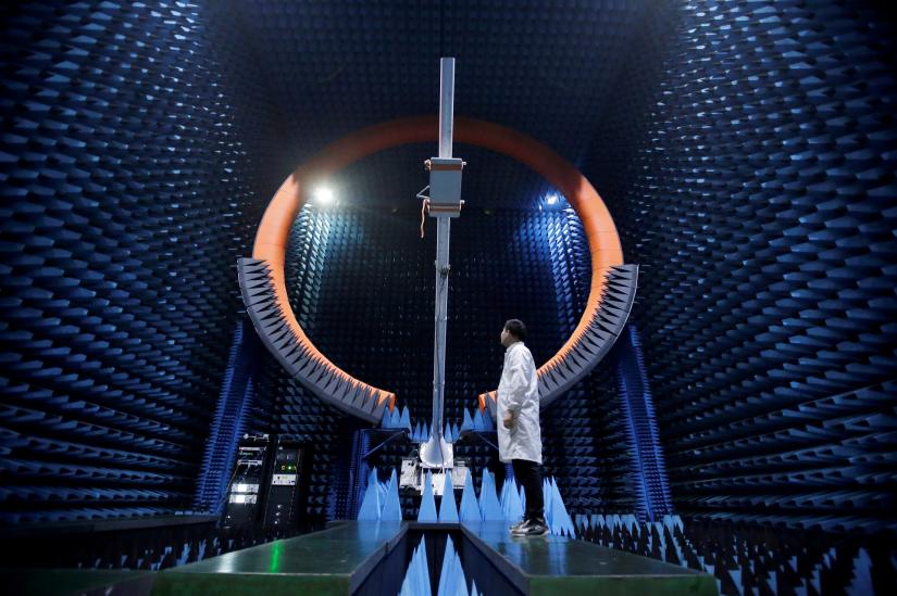 An engineer stands under a base station antenna of 5G in Huawei`s SG178 multi-probe spherical near-field testing system at its Songshan Lake Manufacturing Center in Dongguan, Guangdong province, China May 30, 2019. REUTERS