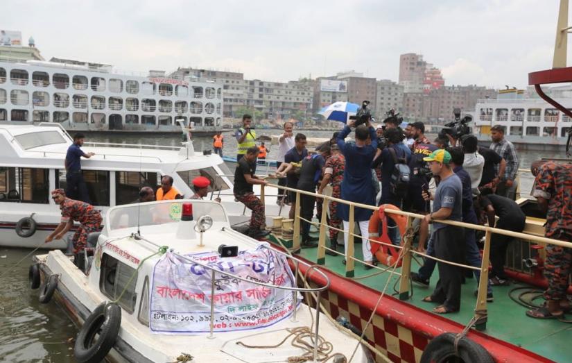 Rescue operation going on by Fire Service, police, and coast guards, along with locals as boat capsizes at Sadarghat on Friday, June 21, 2019. Dhaka Tribune