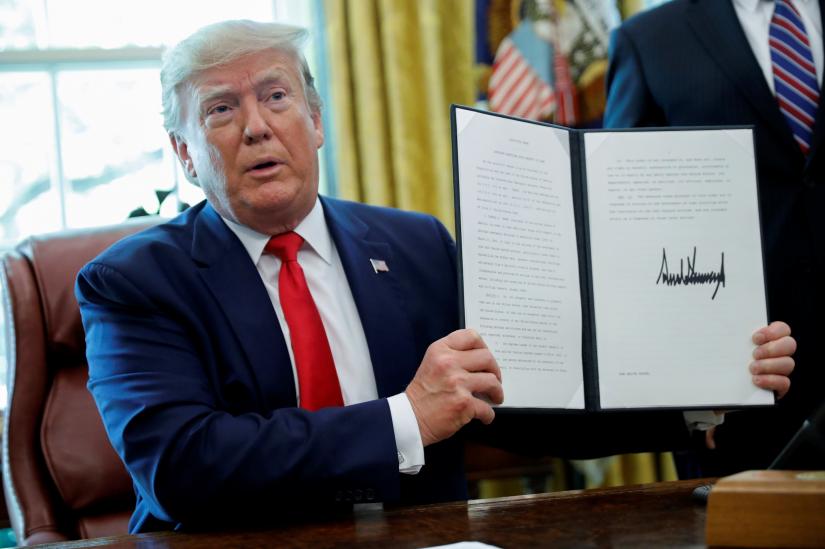 U.S. President Donald Trump displays an executive order imposing fresh sanctions on Iran in the Oval Office of the White House in Washington, U.S., June 24, 2019. REUTERS