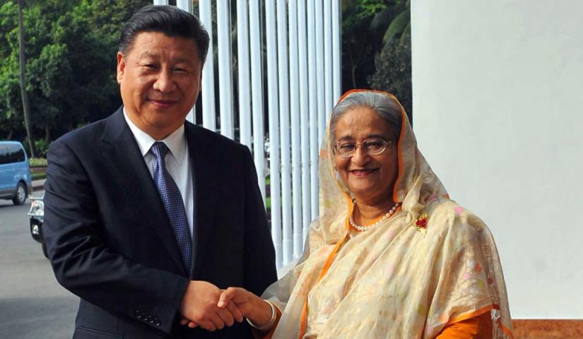 This 2016 file photo shows Bangladesh Prime Minister Sheikh Hasina shaking hands with Chinese President Xi Jinping in Dhaka, Bangladesh.