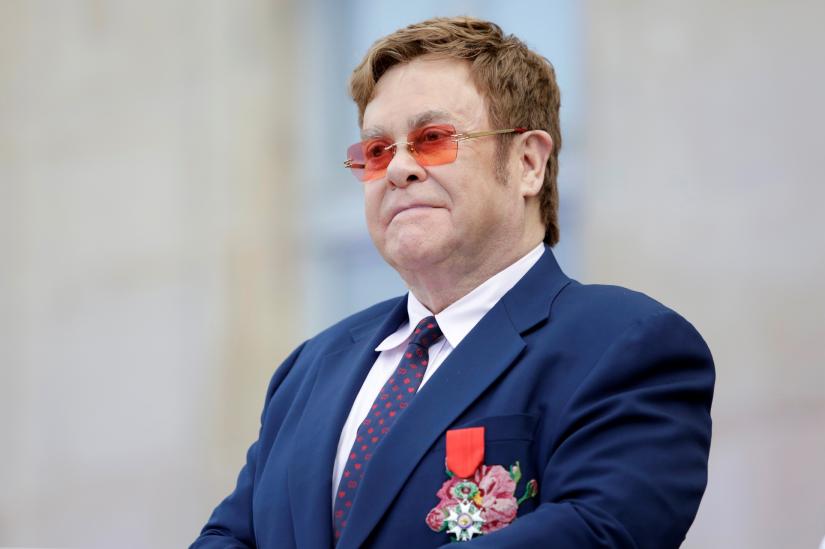 Elton John listens in the courtyard of the presidential Elysee Palace in Paris, France June 21, 2019.Pool via REUTERS
