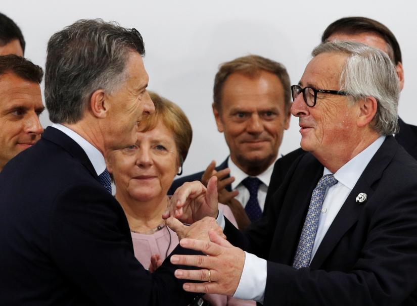 Argentina`s President Mauricio Macri speaks to European Commission President Jean-Claude Juncker during a news conference at the G20 summit in Osaka, Japan, June 29, 2019. REUTERS