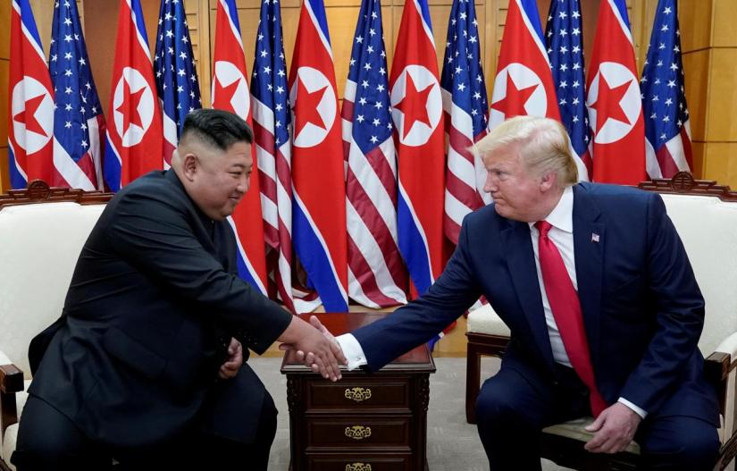 US President Donald Trump shakes hands with North Korean leader Kim Jong Un as they meet at the demilitarized zone separating the two Koreas, in Panmunjom, South Korea, June 30, 2019. REUTERS/File Photo