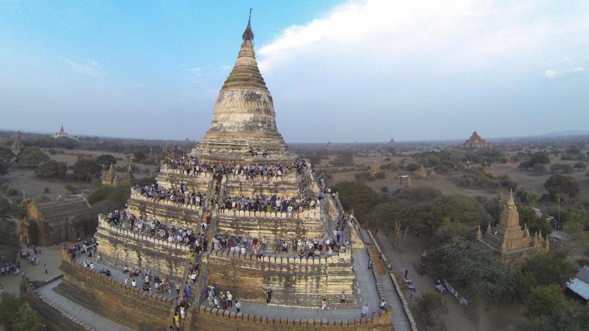 People wait to see the sunset from the top of Shwesandaw Pagoda in the ancient city of Bagan February 13, 2015. REUTERS/File Photo