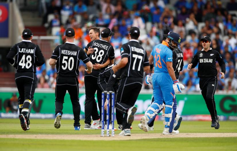 Cricket - ICC Cricket World Cup Semi Final - India v New Zealand - Old Trafford, Manchester, Britain - July 10, 2019 New Zealand`s Trent Boult celebrates with team mates after taking the wicket of India`s Virat Kohli Action Images via Reuters