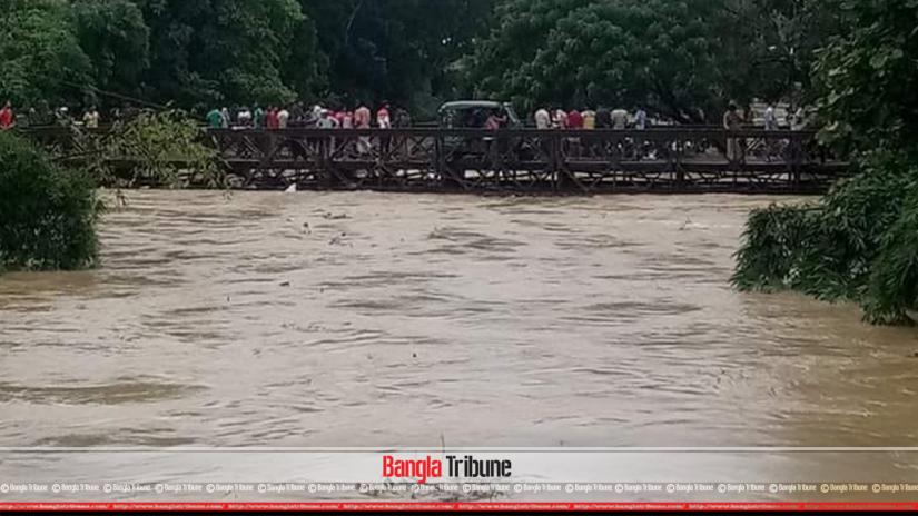 Heavy rainfall raised the water level of Muhuri River to a dangerous level in Feni.