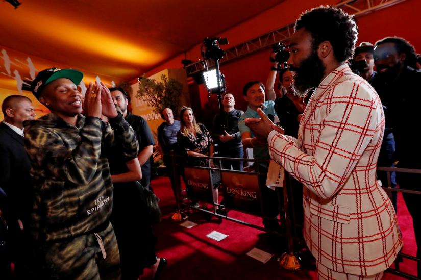 Cast member Donald Glover interacts with Lina Wade on the red carpet during the World Premiere of `The Lion King` in Los Angeles, California, US, July 9, 2019. REUTERS