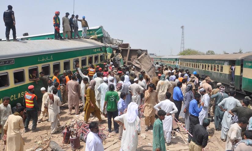 Residents and rescue workers gather near the site after a passenger train collided with a cargo train in Sadiqabad, Pakistan July 11, 2019. REUTERS