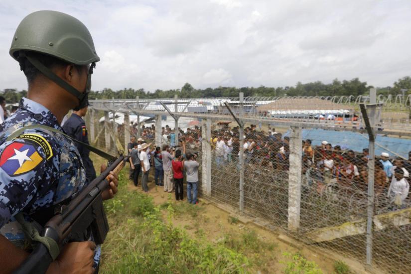 A Myanmar policeman stands guard near a fence at the Bangladesh-Myanmar border in Rakhine state, western Myanmar, in August 2018. EPA-EFE/File Photo