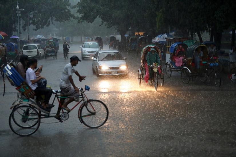 Vehicles are seen on a street during heavy rain in Dhaka, Bangladesh, July 13, 2019. REUTERS