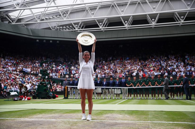 Tennis - Wimbledon - All England Lawn Tennis and Croquet Club, London, Britain - July 13, 2019 Romania`s Simona Halep celebrates with the trophy after winning the final against Serena Williams of the U.S. REUTERS