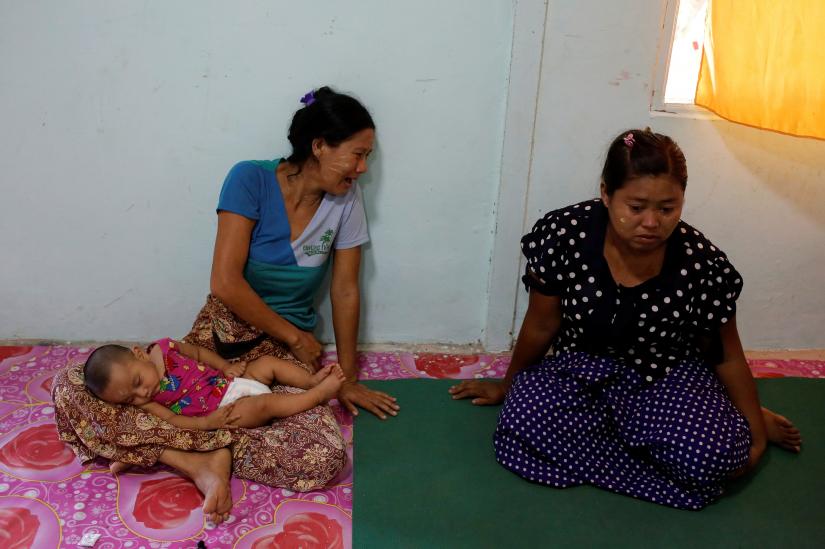 Ah Hla (L) reacts with grief over her husband`s arrest and death next to Thein Mya Yi who`s husband was also arrested in Mrauk U, Rakhine state, Myanmar June 29, 2019. Picture taken June 29, 2019. REUTERS